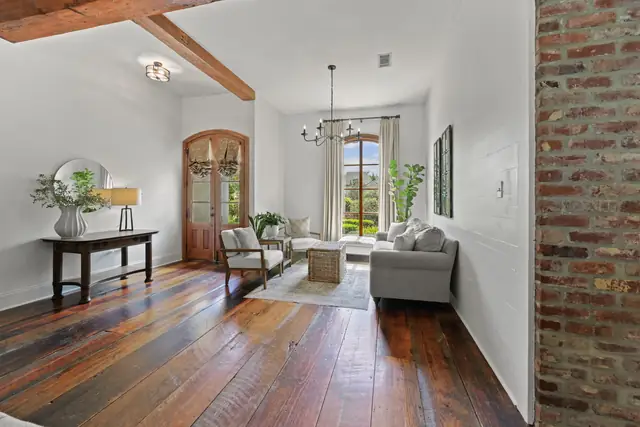 Entry hall with wide-plank wood floors looking toward the great room