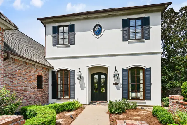 Front entry with arched doors and lanterns