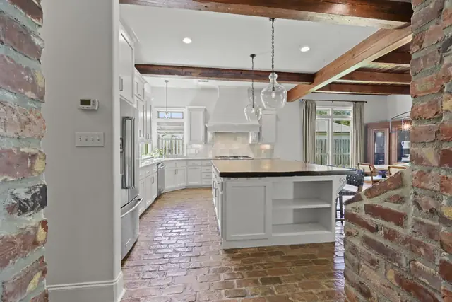 Kitchen seen through the brick archway