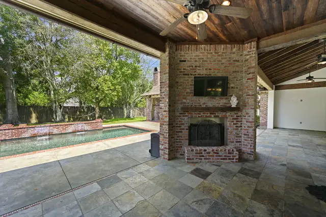 Covered outdoor living area looking toward the pool