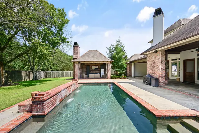 Lap pool with brick coping and water walls